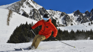 men in orange jacket skiing